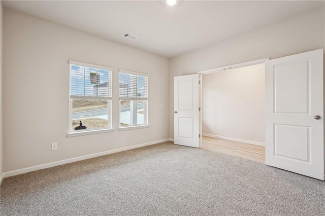 unfurnished bedroom with light colored carpet