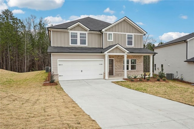 view of front of property with a garage, central air condition unit, and a front yard