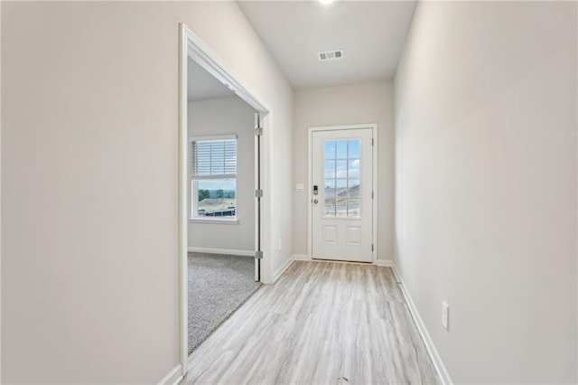 doorway to outside with light wood-type flooring