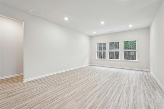 unfurnished room with light wood-type flooring