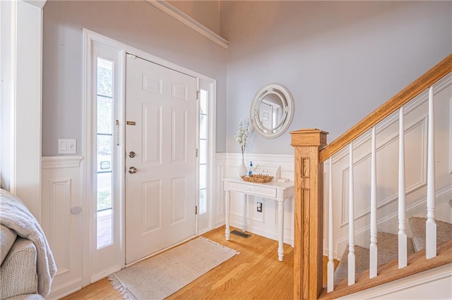 foyer with light hardwood / wood-style flooring and a healthy amount of sunlight