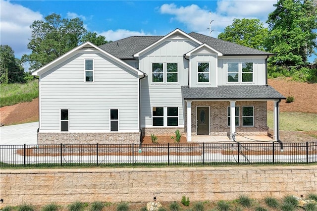 1226 Bloomsbury Ln, Gainesville, GA 30501 - view of front of home with brick siding, board and batten siding, a patio area, and a fenced backyard