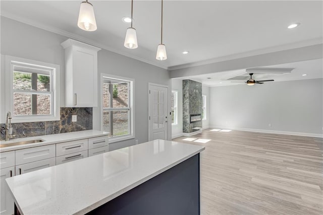 1226 Bloomsbury Ln, Gainesville, GA 30501 - kitchen with a sink, backsplash, white cabinetry, a ceiling fan, and light wood finished floors