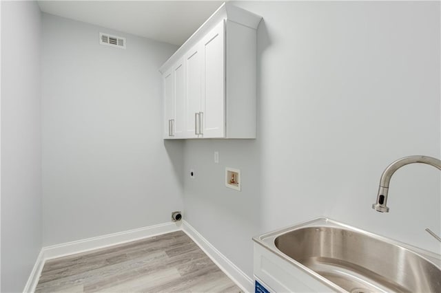 1226 Bloomsbury Ln, Gainesville, GA 30501 - laundry area with cabinet space, hookup for an electric dryer, hookup for a washing machine, light wood-style flooring, and baseboards