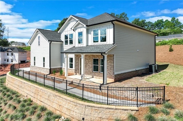 1226 Bloomsbury Ln, Gainesville, GA 30501 - view of front of home with central AC unit, a fenced backyard, a patio area, board and batten siding, and brick siding