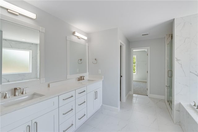 1226 Bloomsbury Ln, Gainesville, GA 30501 - full bath with marble finish floors, double vanity, a marble finish shower, a tub with marble appearance, and baseboards