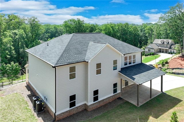 1226 Bloomsbury Ln, Gainesville, GA 30501 - back of house featuring roof with shingles, cooling unit, and a patio area