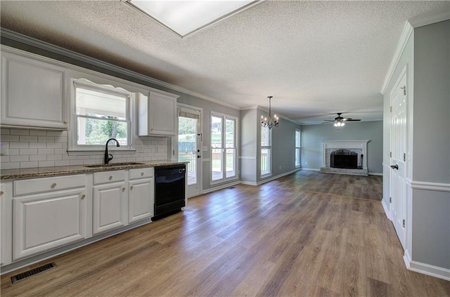 11 Trotters Walk NE, Cartersville, GA 30121 - kitchen featuring black dishwasher, a sink, open floor plan, crown molding, and a fireplace with raised hearth
