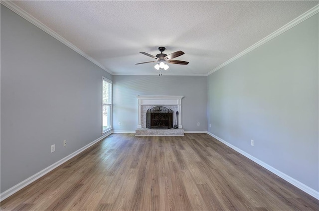 11 Trotters Walk NE, Cartersville, GA 30121 - unfurnished living room with a ceiling fan, wood finished floors, a fireplace with raised hearth, ornamental molding, and baseboards