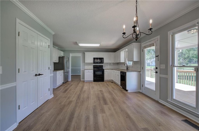 11 Trotters Walk NE, Cartersville, GA 30121 - kitchen with black appliances, a sink, light wood-type flooring, ornamental molding, and white cabinets