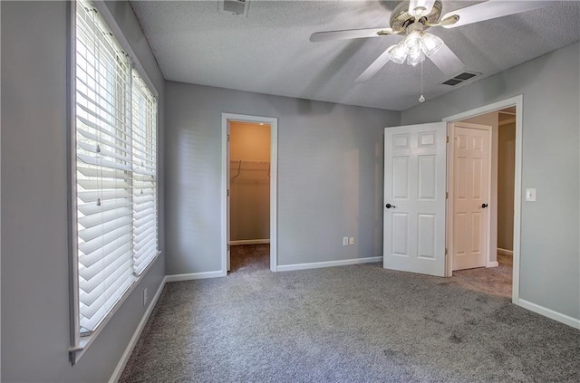 11 Trotters Walk NE, Cartersville, GA 30121 - unfurnished bedroom with a walk in closet, carpet, a textured ceiling, and baseboards