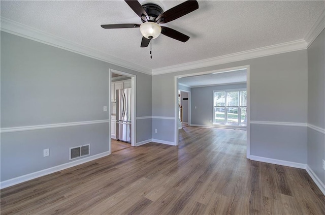 11 Trotters Walk NE, Cartersville, GA 30121 - spare room with wood finished floors, a ceiling fan, a textured ceiling, baseboards, and ornamental molding