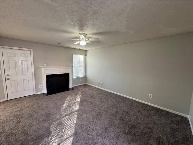 unfurnished living room featuring dark colored carpet, a textured ceiling, and ceiling fan