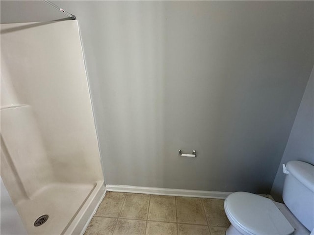 bathroom featuring walk in shower and toilet