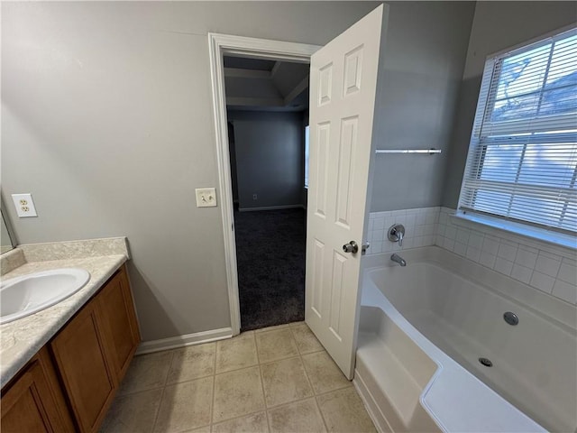 bathroom featuring a bathing tub, tile patterned flooring, and vanity