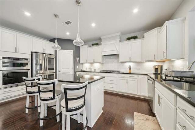 130 W Pier Way, Fayetteville, GA 30214 - kitchen featuring stainless steel appliances, a sink, premium range hood, decorative backsplash, and dark wood-style floors