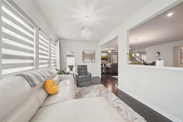 130 W Pier Way, Fayetteville, GA 30214 - living room with a chandelier, dark wood-style floors, baseboards, and stairs