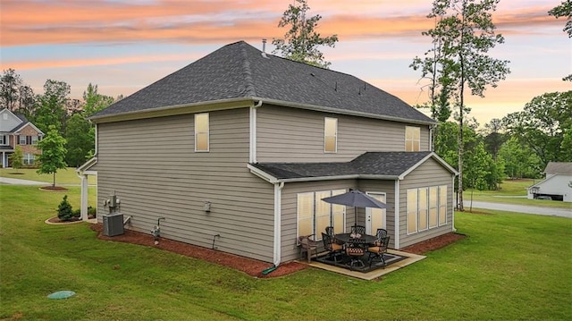 130 W Pier Way, Fayetteville, GA 30214 - back of property at dusk with a yard, a shingled roof, and a patio area
