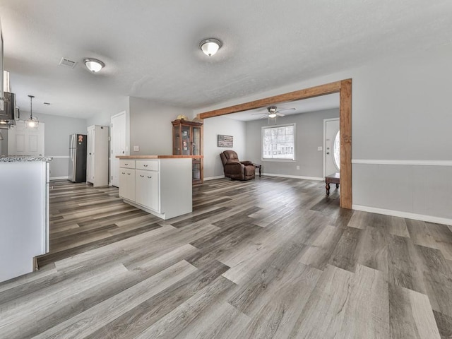 525 Henson Cir, Carrollton, GA 30117 - kitchen with freestanding refrigerator, wood finished floors, white cabinets, and a ceiling fan