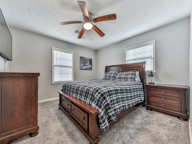 525 Henson Cir, Carrollton, GA 30117 - bedroom with carpet floors, multiple windows, baseboards, and ceiling fan