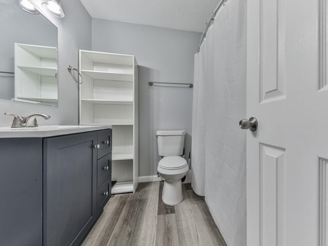 525 Henson Cir, Carrollton, GA 30117 - full bathroom featuring wood finished floors, toilet, and vanity