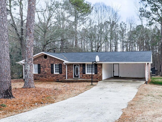 525 Henson Cir, Carrollton, GA 30117 - single story home featuring brick siding, driveway, roof with shingles, and a carport
