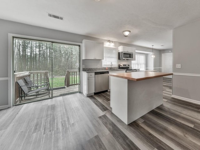 525 Henson Cir, Carrollton, GA 30117 - kitchen featuring stainless steel appliances, butcher block countertops, a sink, white cabinetry, and dark wood-type flooring