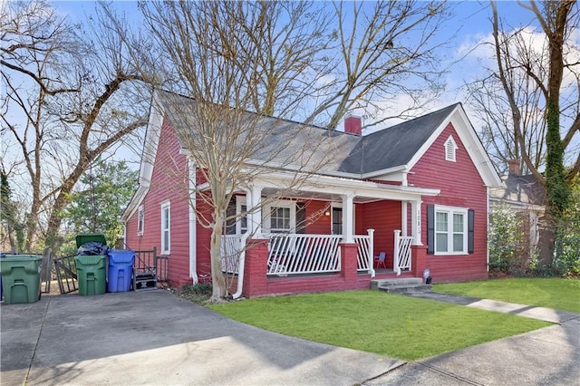 1081 Longley Ave NW, Atlanta, GA 30318 - bungalow-style house with covered porch, a chimney, and a front yard