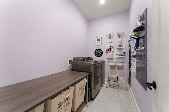 laundry area with washing machine and dryer and light tile patterned flooring