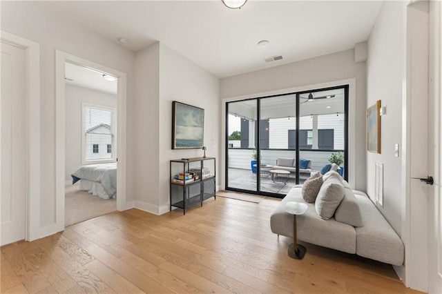 living area featuring a healthy amount of sunlight and light hardwood / wood-style flooring