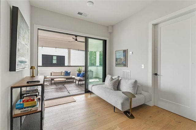 living area featuring ceiling fan and light wood-type flooring