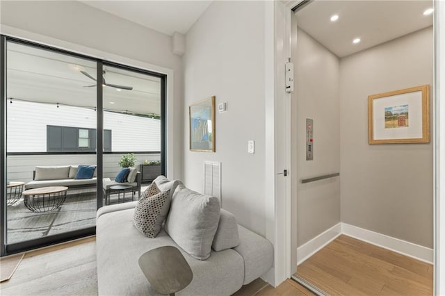 living room featuring light hardwood / wood-style floors and elevator