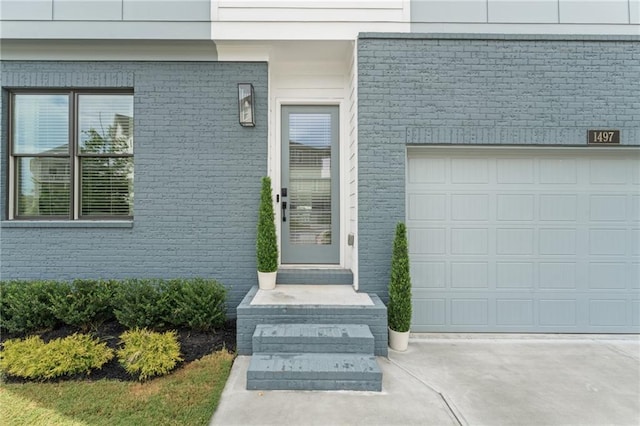 doorway to property with a garage