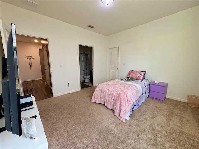 bedroom featuring visible vents, carpet flooring, baseboards, and ensuite bathroom