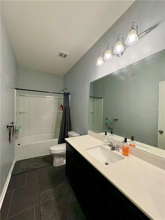 bathroom featuring vanity, shower / tub combo with curtain, toilet, tile patterned floors, and visible vents