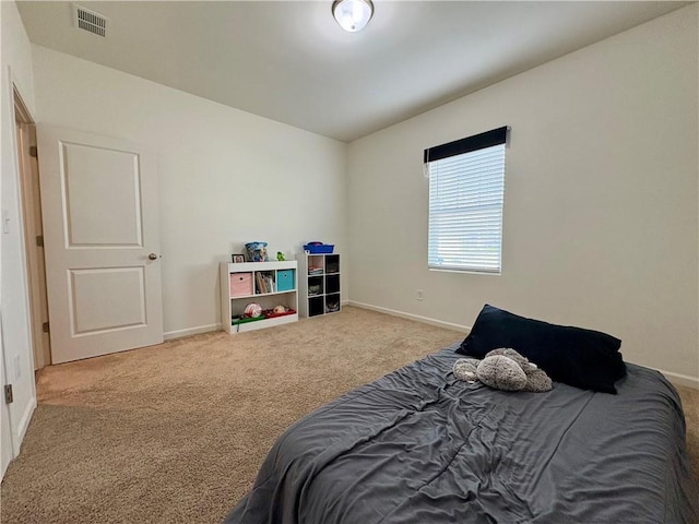 carpeted bedroom with baseboards and visible vents