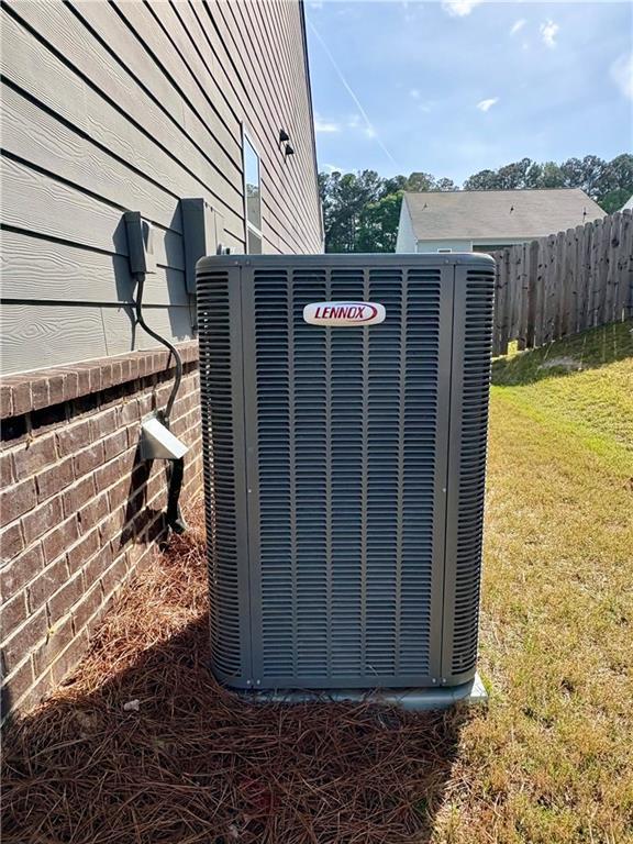 details featuring central air condition unit and fence