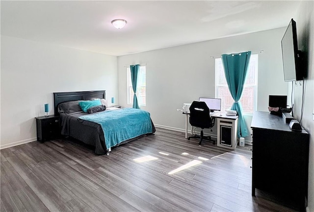 bedroom with baseboards and wood finished floors