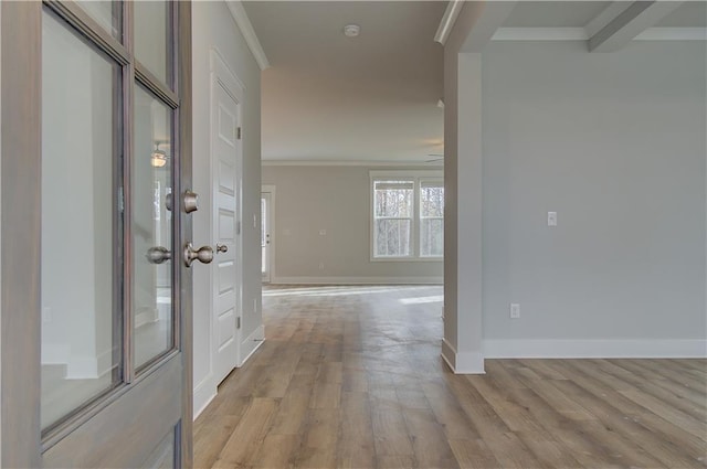 hallway with crown molding and light wood-type flooring