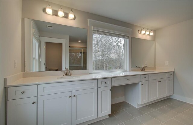 bathroom featuring tile patterned floors, toilet, an enclosed shower, and vanity