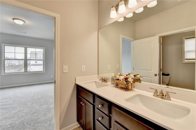 bathroom featuring vanity and toilet