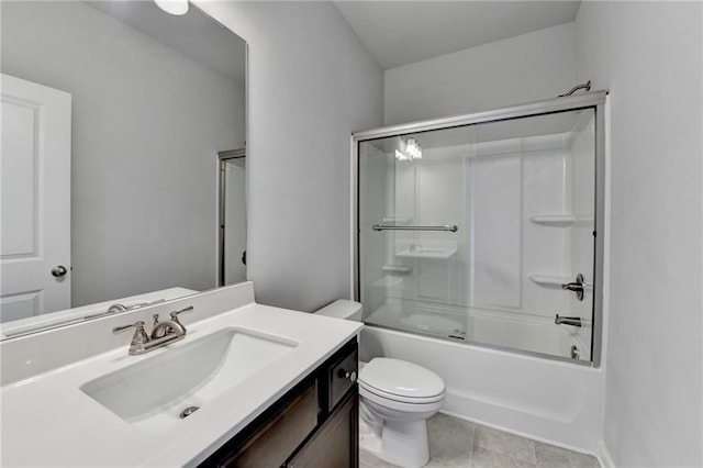 full bathroom featuring tile patterned floors, vanity, toilet, and combined bath / shower with glass door