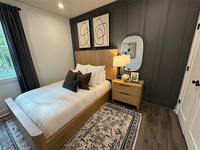 bedroom with dark hardwood / wood-style floors