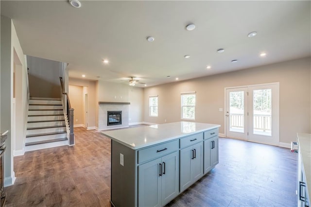 kitchen featuring gray cabinetry, ceiling fan, a center island, and light hardwood / wood-style floors