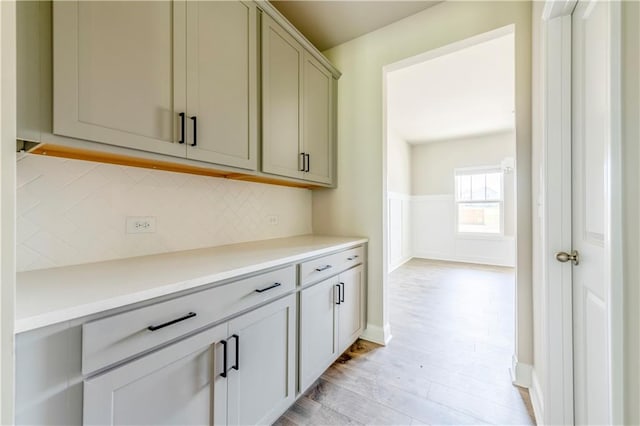 kitchen featuring light wood-type flooring and tasteful backsplash