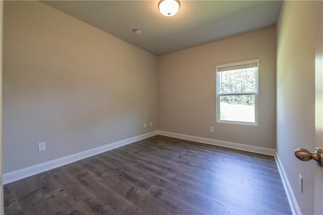 spare room featuring dark hardwood / wood-style floors