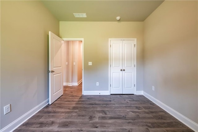 unfurnished bedroom featuring hardwood / wood-style floors and a closet