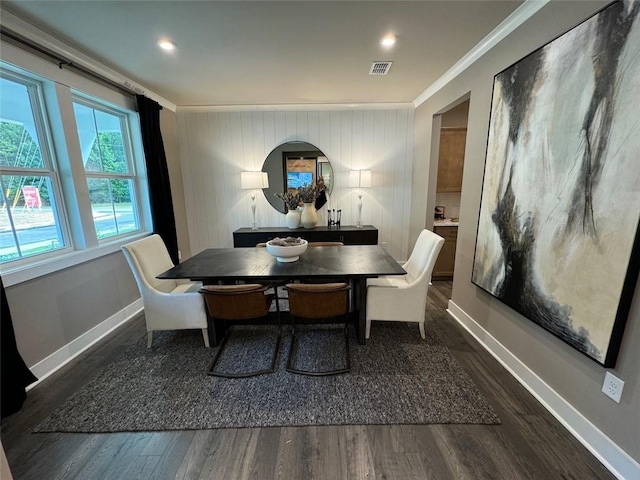 dining room featuring dark wood-type flooring and ornamental molding