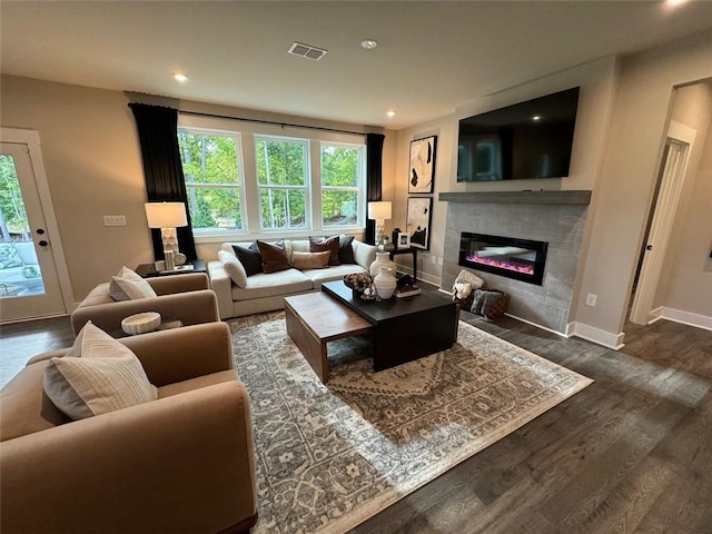 living room with dark hardwood / wood-style floors and a fireplace