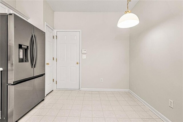 kitchen with decorative light fixtures, baseboards, and stainless steel refrigerator with ice dispenser
